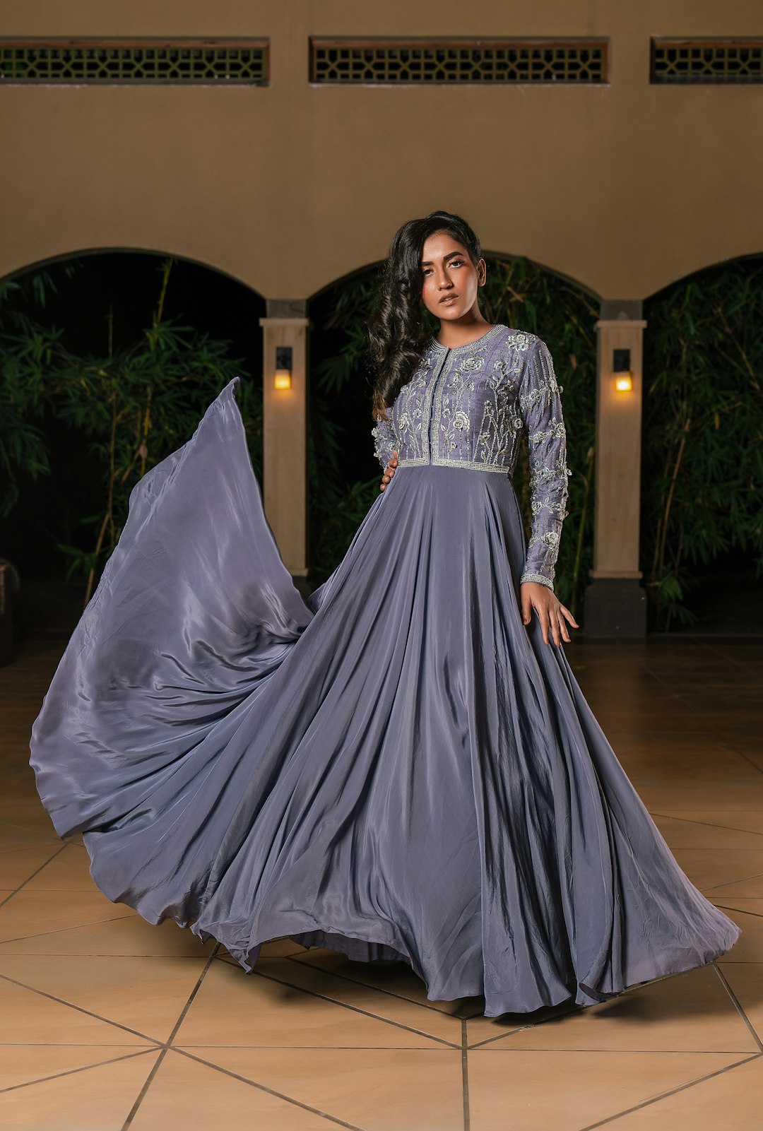 woman-in-a-flowing-grey-dress-with-intricate-embellishments-nevvn3t0aha